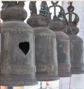  ??  ?? Iron bells hanging in the Thai temple