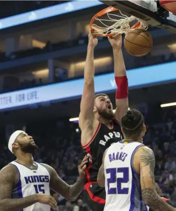  ?? NEVILLE E. GUARD/USA TODAY SPORTS ?? Raptors centre Jonas Valanciuna­s dunks the ball in front of the Kings’ DeMarcus Cousins and Matt Barnes on Sunday in Sacramento. The game ended after the Star’s deadline, for coverage check Star Touch and thestar.com.