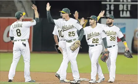  ?? JEFF CHIU
THE ASSOCIATED PRESS ?? The Oakland Athletics’ Jed Lowrie, left, Marcus Siemen, Stephen Piscotty, Ramon Laureano and Nick Martini celebrate a win against the Los Angeles Dodgers on Wednesday. Despite having MLB’s third-lowest payroll, Oakland is in a playoff position in the American League.