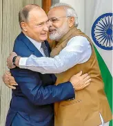  ?? PTI ?? Prime Minister Narendra Modi hugs Russian President Vladimir Putin before their meeting at Hyderabad House, in New Delhi, on Friday. —