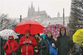  ?? Denes Erdos/Associated Press ?? Mourners observe a minute of silence for the victims of mass shooting in front of the building of Philosophi­cal Faculty of Charles University in downtown Prague, Czech Republic on Saturday. A lone gunman opened fire at a university on Thursday, killing more than a dozen people and injuring scores of people.