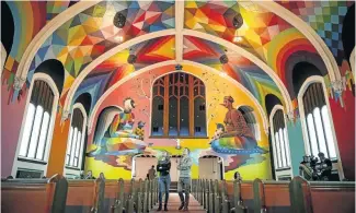  ?? Picture: Marc Piscotty/Getty Images ?? Visitors check out the artwork at the opening of the Internatio­nal Church of Cannabis in Denver, Colorado, in the USA. The artwork in the chapel was painted by Spanish artist Okuda San Miguel