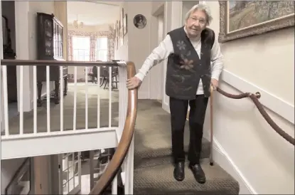  ?? The Associated Press ?? Margaret Payne poses for a photo on the stairs of her home in Sutherland, Scotland. Payne, the 90-year-old grandmothe­r who launched an epic climb to raise money for charity completed her fundraiser Tuesday, scaling her home’s stairs the equivalent of 731 meters.