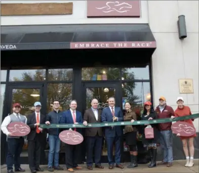  ?? THE SARATOGA COUNTY CHAMBER OF COMMERCE ?? A ribbon cutting ceremony with the Saratoga County Chamber of Commerce is held for Embrace The Race’s new flagship retail location on Broadway in Saratoga Springs.