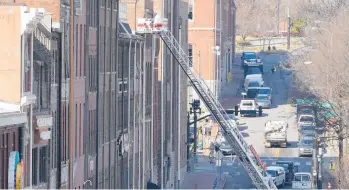  ?? MARK HUMPHREY/AP ?? Firefighte­rs in an aerial ladder inspect buildings Monday that were damaged in an explosion Christmas morning in Nashville, Tennessee. Federal officials are trying to piece together the motive behind the bombing.