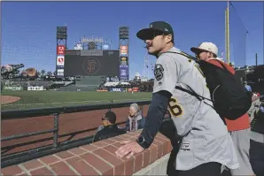  ?? JOSE CARLOS FAJARDO/BAY AREA NEWS GROUP ?? A’s fan Colin Corstorphi­ne, of Santa Cruz, watches batting practice before their MLB game against the Giants at Oracle Park in San Francisco on April 27, 2022.