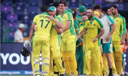 ?? Photograph: David Gray/AAP ?? Australia captain Aaron Finch (second left) embraces teammate Marcus Stoinis (left) after a five-wicket T20 World Cup win against South Africa.