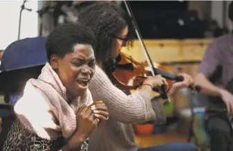  ?? Liz Hafalia / The Chronicle ?? Ivorian vocalist Fely Tchaco rehearses last month with Real Vocal String Quartet in Berkeley, ahead of the album-release performanc­e at Yerba Buena Center for the Arts for “Culture Kin.”