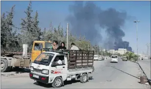  ??  ?? Civilians flee as smoke rises over the Syrian city of Aleppo after missiles fired from a fighter jet hit a tanker in Bab al-Nayrab on Sunday.