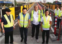  ??  ?? ALABANG RAMP OPENED – San Miguel Corp. President Ramon S. Ang, DPWH Secretary Mark Villar and Transporta­tion Secretary Arthur Tugade (left, 2nd, and 3rd from left, respective­ly) open the new two-lane Alabang Skyway ramp and reopen a third lane at the at-grade section to ease the flow of traffic in that portion of the South Luzon Expressway. Tugade said the newly completed two-lane ramp was finished ahead of schedule.