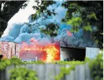  ?? BARRY GRAY THE HAMILTON SPECTATOR ?? Fire destroys the former Mr. Used on Barton Street East on Friday. There were no immediate reports of injuries.