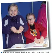  ??  ?? Emilia and Sarah Podmore help to make bird food