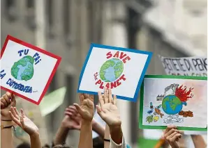  ??  ?? Students demonstrat­e recently during a worldwide protest demanding action on climate change. The protests were inspired by Swedish teenager Thunberg (pic, right), who spoke to world leaders at a United Nations summit recently. — AP