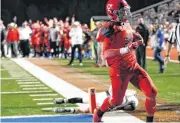  ??  ?? Carl Albert’s Jason Taylor carries the ball for a touchdown against Skiatook on Friday.