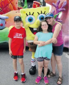  ??  ?? Patti Biwer, shown with daughter Acacia and son Andrew at Disney World, says the shutdown of SASKFEAT is a loss for families of autistic children.