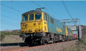  ??  ?? Pairs of Class 86/6 were the usual order on container trains, as demonstrat­ed on another beautiful March day, too early in the year for the weeds to grow too tall on the lineside for low-level photograph­y, allowing a dramatic image to be captured.
No. 86612 leads No. 86605 north at Heamies Farm on March 26, 2012.