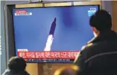  ?? LEE JIN-MAN AP ?? People watch a news program reporting about North Korea’s missile launch Friday in Seoul, South Korea.