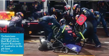  ??  ?? Technician­s change tyres to Red Bull driver Daniel Ricciardo of Australia in the pit lane Photo: AP