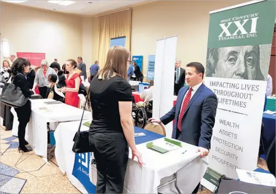  ?? Keith Srakocic Associated Press ?? RESEARCH HAS FOUND that 65% of older workers say age is a barrier to getting a job. Above, job seekers at a job fair in Pittsburgh in March.