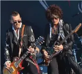  ?? — AFP ?? ( Right) Actor Johnny Depp ( left) is flanked by guitar player Joe Perry as they perform with The Hollywood Vampires band as part of the Hellfest metal music festival in Clisson, France on Friday.