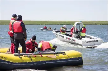  ?? Herald photo by Greg Bobinec ?? Lethbridge Fire &amp; Emergency Services boat is on the choppy waters of Stafford Lake Tuesday morning for training exercises in boat manoeuvrin­g for water rescue before more people take to the waters this summer.