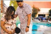  ?? Dania Maxwell Los Angeles Times ?? STEPHANIE AND Kevin Zapata with their son Kruz, 2, at the Monrovia public library on Friday.