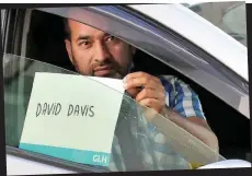  ??  ?? Taxi for David: A driver collects Mr Davis who, following his resignatio­n, has now lost his ministeria­l chauffeur