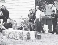  ??  ?? Police officers look over a slab of concrete pulled out of the basement of a home in Milton, Pennsylvan­ia. Investigat­ors hope cement taken from the basement will solve the 1989 disappeara­nce of Barbara Elizabeth Miller by determinin­g if her remains...