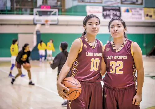  ?? PHOTOS BY GABRIELA CAMPOS/THE NEW MEXICAN ?? Fraternal twins Leanna, left, and Camilla Lewis were born eight minutes apart. The Santa Fe Indian School seniors play on the Lady Braves basketball team and are headed to Stanford for academics next year.