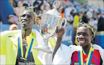  ?? Jim Rogash, Afp-getty Images ?? Kenyans Wesley Korir and Sharon Cherop captured the men’s and women’s titles at the 116th running of the Boston Marathon on Monday.