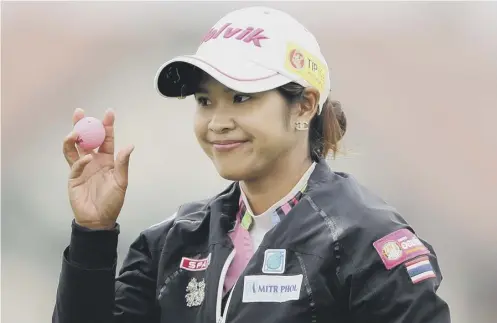  ?? PICTURE: GETTY ?? Pornanong Phatlum smiles after a par on the 17th en route to a second-round 67 at the Ricoh Women’s British Open.