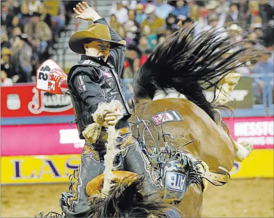  ?? Chase Stevens Las Vegas Review-journal @csstevensp­hoto ?? Zeke Thurston of Canada rides Best Hope in saddle bronc competitio­n Friday during the second go-round of the National Finals Rodeo at the Thomas &amp; Mack Center.