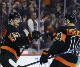  ?? THE ASSOCIATED PRESS ?? Philadelph­ia Flyers’ Joel Farabee, left, and Sean Couturier celebrate after a goal during the second period of an NHL hockey game against the Colorado Avalanche, Saturday night.