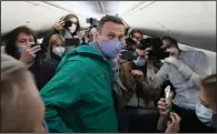  ?? (AP/Mstyslav Chernov) ?? Russian opposition leader Alexei Navalny is surrounded by journalist­s in a plane Sunday near Berlin before his flight to Moscow, where he was detained by police. More photos at arkansason­line. com/118navalny/.