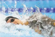  ?? Al Bello / Getty Images ?? American swimmer Caeleb Dressel set the Olympic record of 47.02 seconds in winning the men’s 100meter freestyle.