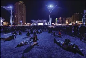  ?? CHASE STEVENS/LAS VEGAS REVIEW-JOURNAL ?? Attendees relax on the grass before John Legend performs on the main stage during the Rock in Rio USA festival on May 16, 2015.