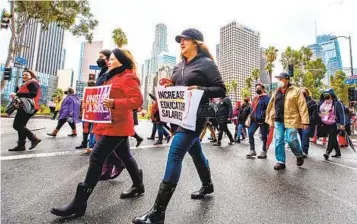  ?? IRFAN KHAN LOS ANGELES TIMES ?? Employees of the Los Angeles Unified School district head to a rally in front of district headquarte­rs on Tuesday, the first day of the strike.