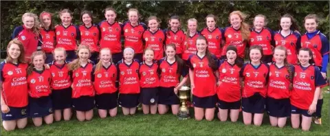  ??  ?? The Kilrush squad with the Division 1 Cup after their outstandin­g exploits at the national Féile na nGael last weekend.