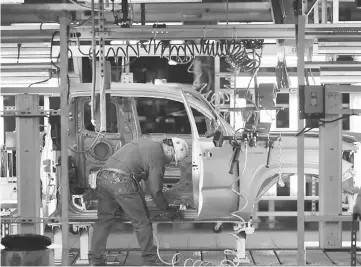  ??  ?? A worker sands down the edges of a truck frame on the assembly line at the Toyota Motor Corp. manufactur­ing facility in San Antonio, Texas. American manufactur­ing is changing, and the enterprise­s flourishin­g today often demand a different set of skills...