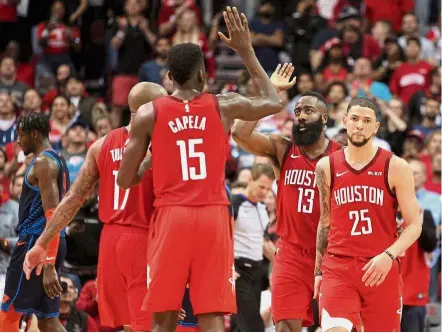  ??  ?? Good show: Houston Rockets guard James Harden (No. 13) celebrates a made basket with Rockets centre Clint Capela (No. 15) against the Oklahoma City Thunder during the fourth quarter at the Toyota Centre on Tuesday. — Reuters