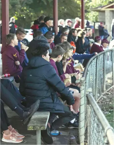  ??  ?? Real footy weather arrived on Saturday with chilly temperatur­es and periodic showers forcing specators, including some at Drouin, to rug up and seek shelter from the elements.