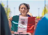  ?? ROBERTO E. ROSALES/ JOURNAL ?? Margarita Perez holds the Mexican flag outside the Hispanic Cultural Center on Saturday during the “Unite Against Family Separation” event aimed at speaking out against President’s Trump’s family separation policy.