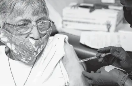  ?? Rogelio V. Solis / Associated Press ?? Linda Busby, 74, receives the Johnson & Johnson vaccine Wednesday at the Aaron E. Henry Community Health Service Center in Clarksdale, Miss. The Mississipp­i Department of Human Services is teaming up with community senior services statewide.