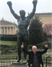  ??  ?? John fists the air at the ‘Rocky’ statue