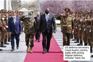  ??  ?? US defence secretary Lloyd Austin, centre, walks with acting Afghan defence minister Yasin Zia