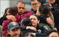  ?? ?? Oakland Police officers console each other at Highland Hospital on Friday. Le is the 54th OPD officer to die in the line of duty.