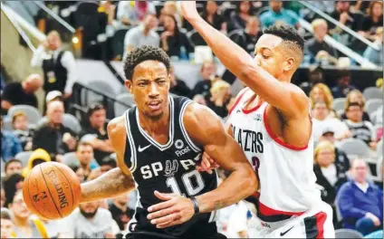  ?? (AP Photo/Darren Abate) ?? San Antonio Spurs' DeMar DeRozan (10) drives around Portland Trail Blazers' C.J. McCollum during the first half of an NBA basketball game, Sunday, Dec. 2, 2018, in San Antonio. San Antonio won 131-118.