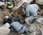  ?? REMO CASILLI/REUTERS ?? A man is rescued Wednesday following an earthquake that heavily damaged the town of Amatrice in central Italy.