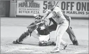  ??  ?? Big hit for Diaz: St. Louis Cardinals shortstop Aledmys Diaz (36) hits a double to score Jeremy Hazelbaker during the fifth inning of a game against the Miami Marlins on Thursday in Miami. The Cardinals defeated the Marlins 5-4.