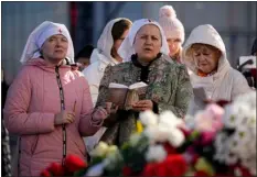  ?? AP PHOTO/ALEXANDER ZEMLIANICH­ENKO ?? Women pray near the Crocus City Hall on the western edge of Moscow, Russia, Monday, March 25, 2024.